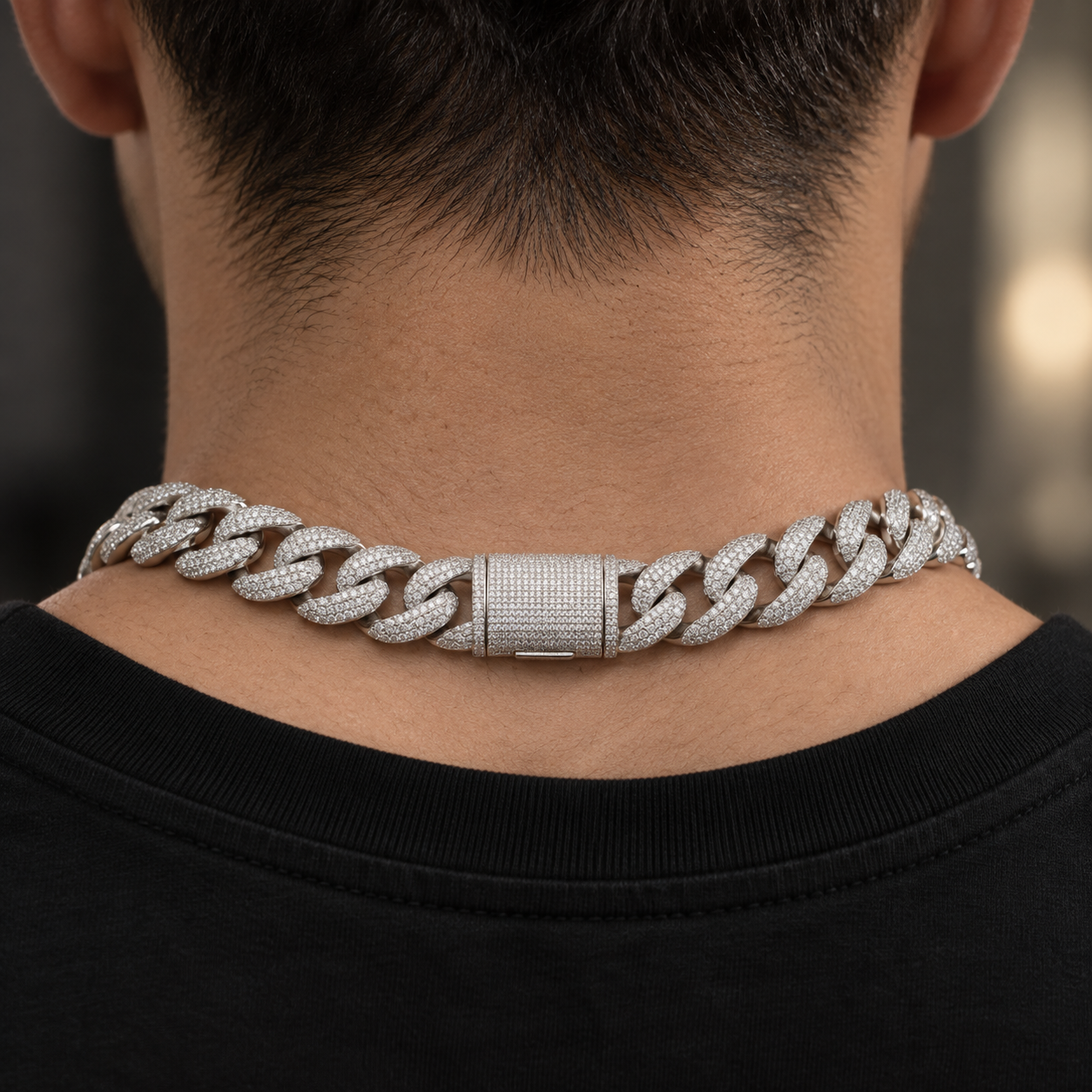 Back view of the 20 mm iced Cuban link chain showing the pave box clasp at the nape